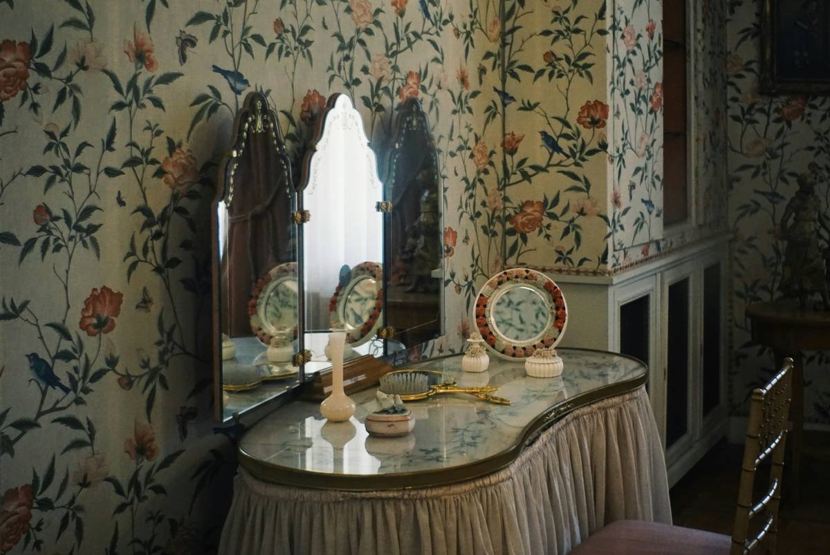 Modern dressing table with organized makeup, soft lighting, and closed storage drawers