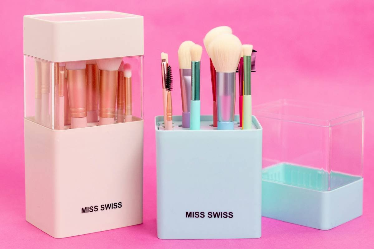 Compact cosmetic organizer case holding makeup brushes, compacts, and skincare minis on a clean vanity