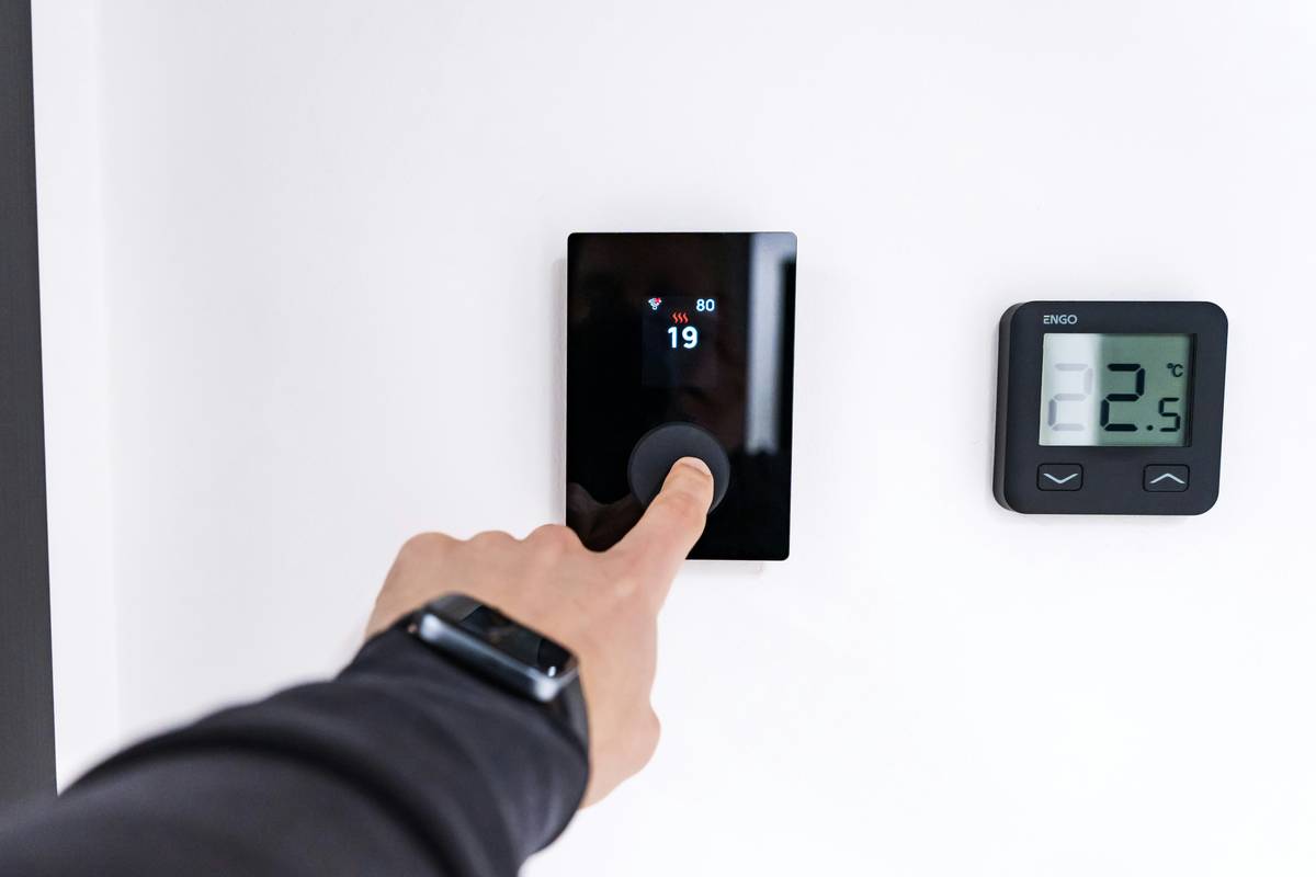 Modern bathroom with g digital signage systems embedded beside an illuminated high-tech mirror